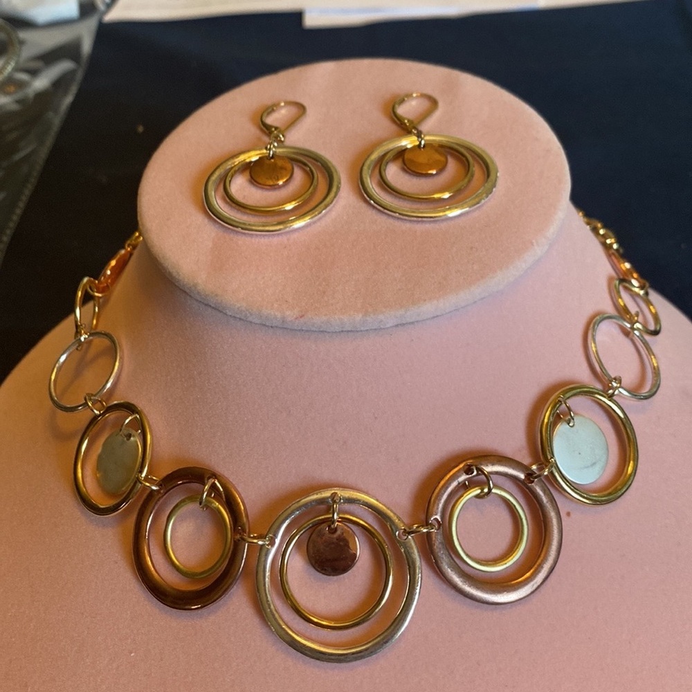 Gold colored necklace and earrings set with silver /bronze accents.